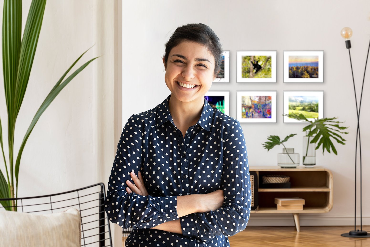 A happy G.O.A.T art customer from Florida with purchased art in background